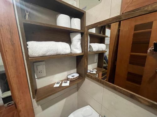 a bathroom with a toilet and a mirror and towels at Hostería CASA SAN LUIS in Quito