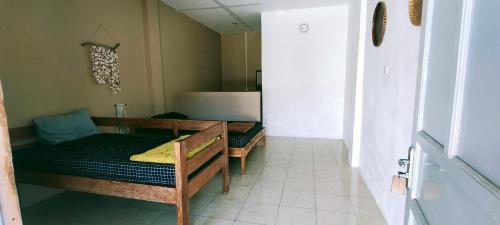 a room with two bunk beds in a room at Scar Reef Homestay in Jereweh