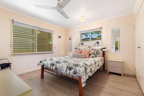 a bedroom with a bed and a window at Relaxed Urangan Living at the Poolside Bungalow in Urangan