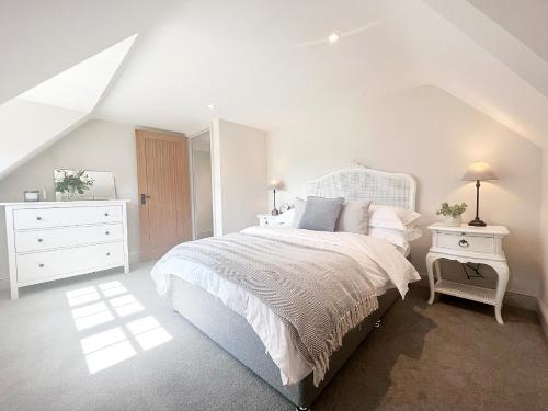 a bedroom with a white bed and a white dresser at The Old Stables 3 - Uk35690 in West Winterslow