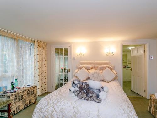 a bedroom with a bed with teddy bears on it at The Garden House-uk11837 in Dronfield