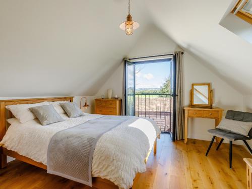 a bedroom with a bed and a large window at Knoll Cottage - Uk31171 in Brent Knoll