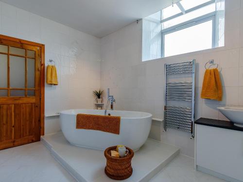 a bathroom with a large tub and a sink at Torreagles in Mintlaw