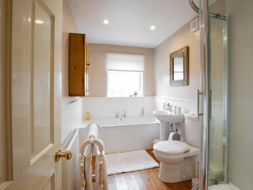 a bathroom with a tub and a toilet and a sink at The Nook in Alnwick
