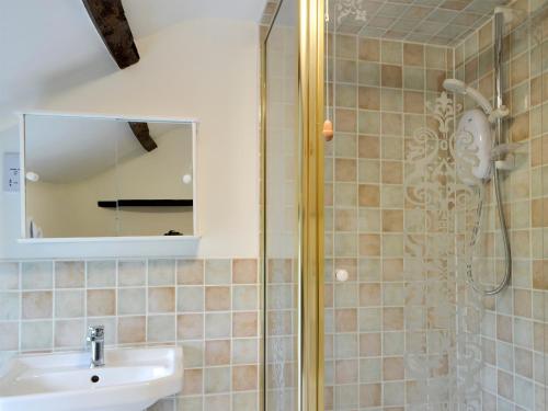 a bathroom with a sink and a shower at Dardy Cottage in Crickhowell