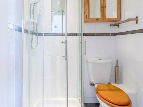 a bathroom with a toilet with a glass shower at South Cliff in Bessingby