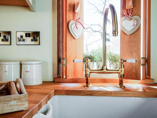 a kitchen with a sink and a window at Trewalter Treehouse in Brecon