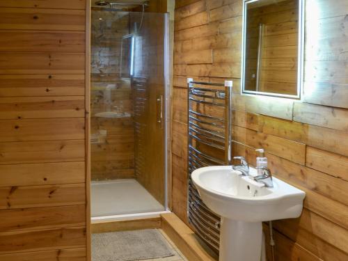 a bathroom with a sink and a shower at The Sunset Cabin in Beccles