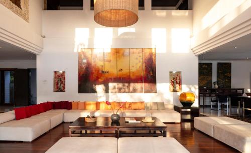 a living room with couches and a painting on the wall at Villa Manis Canggu in Canggu