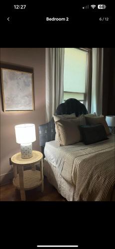 a bedroom with a bed and a table with a lamp at Over-Time in Galveston