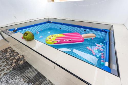 a toy pool with a hot dog on a shelf at Happy Gather Homestay 欢聚阁 in Ipoh