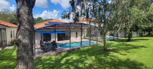 an overhead view of a house with a swimming pool at Cheerful 4bed 3bath with pool home near Disney in Kissimmee