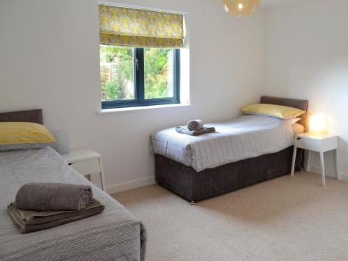a bedroom with two beds and a window at The Perch-uk12929 in St. Just