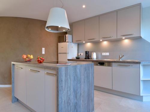 a kitchen with white cabinets and a counter top at Charmant appartement rénové pour 4 pers avec terrasse à Hunawihr - FR-1-744-14 in Hunawihr