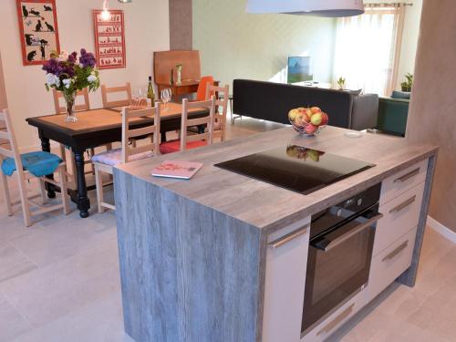 a kitchen with a island in the middle of a room at Charmant appartement rénové pour 4 pers avec terrasse à Hunawihr - FR-1-744-14 in Hunawihr