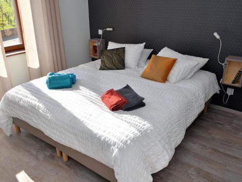 a large white bed with three pillows on it at Charmant appartement rénové pour 4 pers avec terrasse à Hunawihr - FR-1-744-14 in Hunawihr