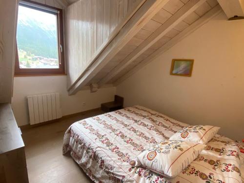 une chambre avec un lit dans un grenier dans l'établissement Superbe duplex face aux pistes, sud, 8 pers, 3 ch, balcon, parking, proche commerces - FR-1-445-198, à Montgenèvre