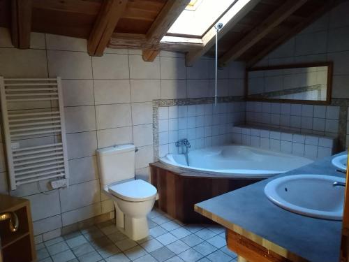 a bathroom with a tub and a toilet and a sink at Chalet Valloire, 5 pièces, 12 personnes - FR-1-263-533 in Valloire