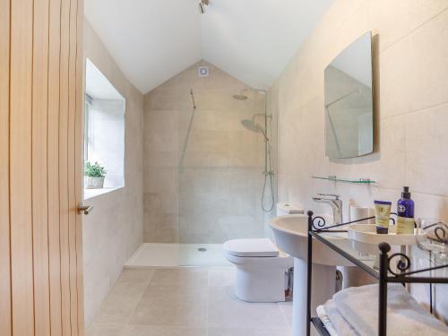 a bathroom with a shower and a toilet and a sink at The Stable - Uk35021 in Long Houghton