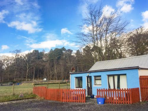 a blue and white house with a orange fence at The Cairngorms - Uk7096 in Contin