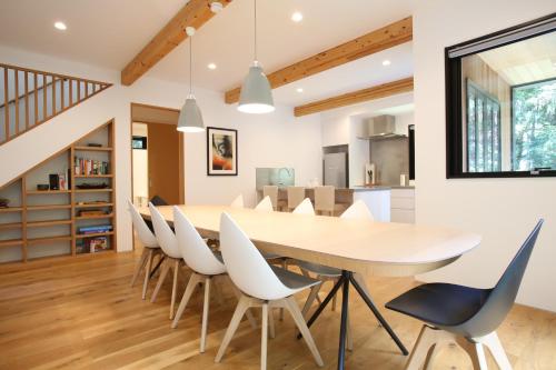 a dining room with a table and chairs at SEVEN TREES BY AOKIKO in Omachi