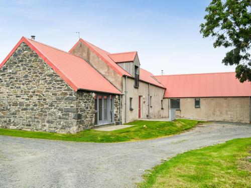 an old stone building with a red roof at The Barn - Uk33396 in Isle of Gigha