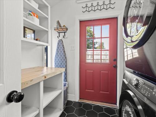 a red door in a small kitchen with a counter at Cozy Arlington Bungalow 4/Mins to AT&T Stadium in Arlington