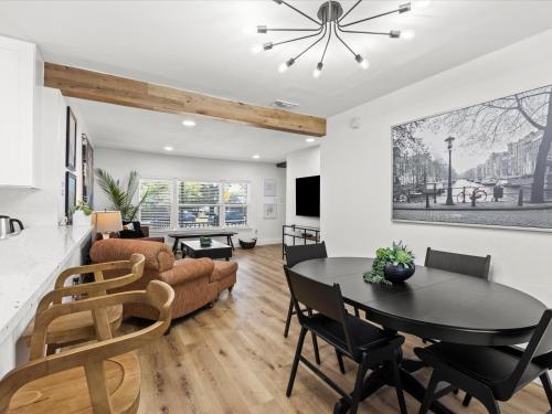 a dining room and living room with a table and chairs at Cozy Arlington Bungalow 4/Mins to AT&T Stadium in Arlington