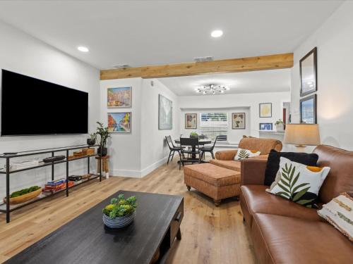 a living room with a couch and a tv at Cozy Arlington Bungalow 4/Mins to AT&T Stadium in Arlington