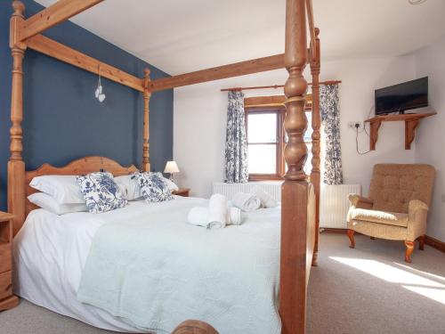 a bedroom with a large bed with a wooden frame at Atlantic House in Bideford