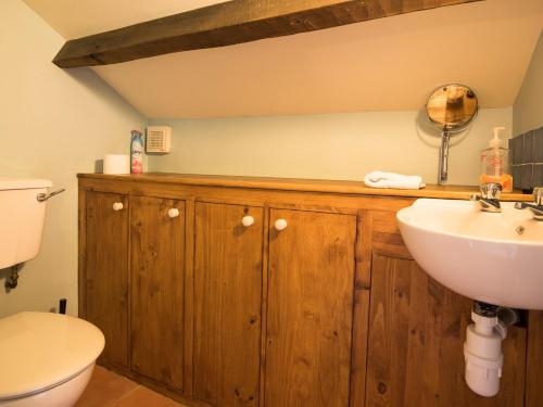 a bathroom with a sink and a toilet at Sundial Cottage in Gammersgill