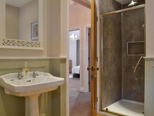 a bathroom with a sink and a shower at Rowan House in Threlkeld