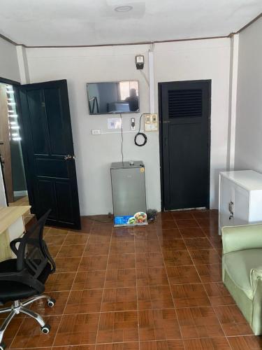 a room with two doors and a desk and a chair at Batman guesthouse in Vientiane