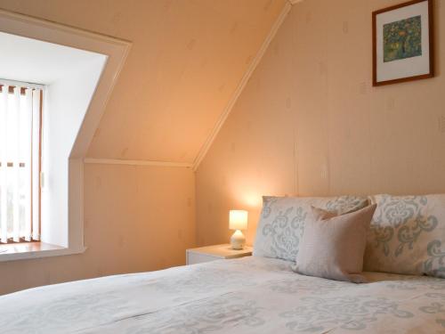 a bedroom with a bed and a window at Hillside - Uk32930 in Gairloch