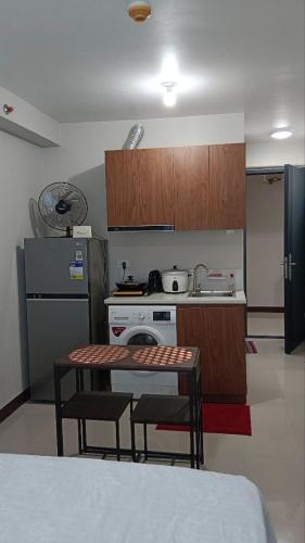 a kitchen with a table and two chairs and a stove at Seaview and Cityview Mactan,Cebu in Lapu Lapu City