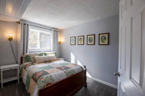 a bedroom with a bed and a window at The Mint Cottage with Garden in Anchorage