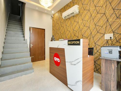 a reception desk with a stop sign in a lobby at OYO Flagship Golden A in Ludhiana
