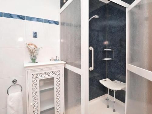 a bathroom with a shower and a sink and a toilet at Taigh Nan Eilean in Valtos