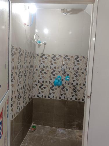a shower in a bathroom with a shower curtain at Narayan nivas homestay in Ujjain