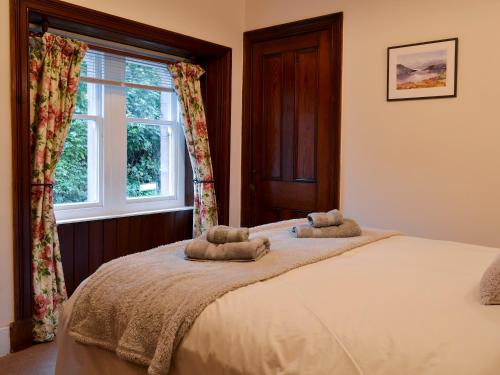 a bedroom with a bed with two towels on it at Lealholme in Bassenthwaite