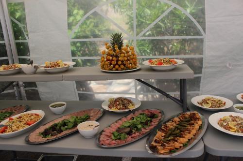 a buffet with many plates of food on a table at Le Prieuré in Saint-Dalmas-de-Tende