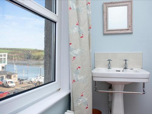a bathroom with a sink and a window at The Lookout in Salcombe