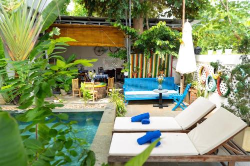 a patio with a pool and chairs and a table at 5 Coconut Villa in Hoi An