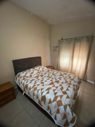 a bedroom with a large bed in a room at Casa agradável com lareira in Chuí