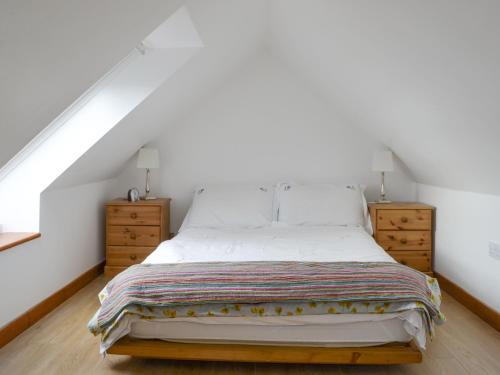 a bedroom with a bed and two night stands at The Old Dye House in Hallin