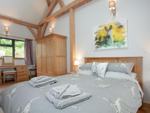 a bedroom with a bed with towels on it at Oaklands in Stockleigh Pomeroy