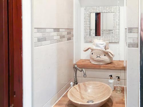 a bathroom with a wooden sink and a mirror at The Gate House in Markinch