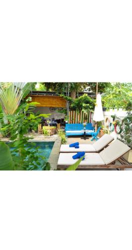 a patio with a pool and a table with a lamp at 5 Coconut Villa in Hoi An