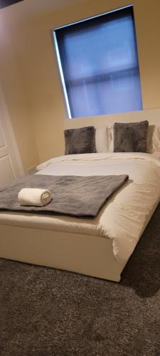 uma cama num quarto com uma janela em 14 Decent Homes em Dukinfield