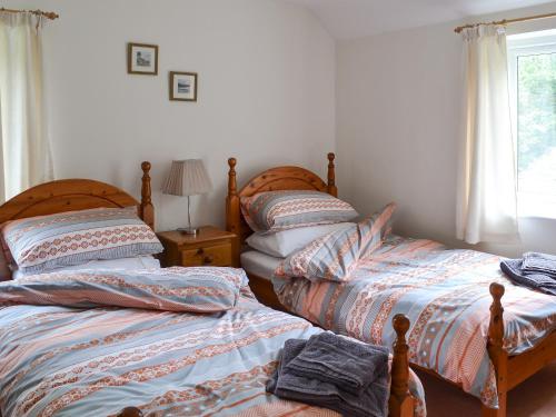 two beds sitting next to each other in a bedroom at Sunny Beck in High Nibthwaite